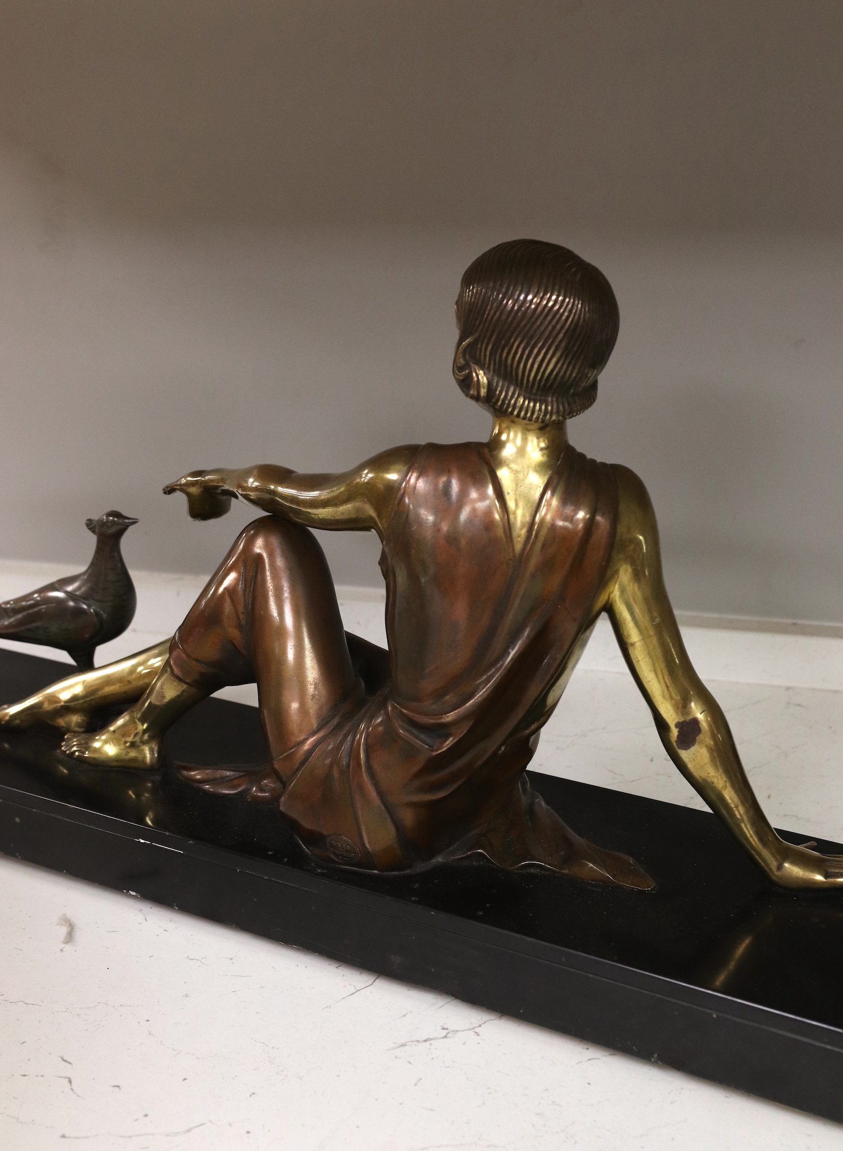 An Art Deco figural bronze of a girl with a peacock, VRAI Bronze foundry mark, signed Godard, on a marble base, base 65cm long, 30cm high. Condition - fair to good